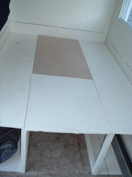 table lowered between benches with filler piece for bed