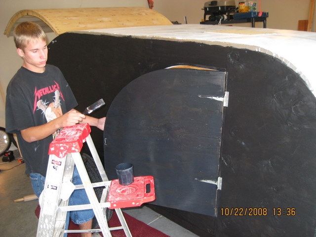 My son Casey painting the doors to seal them