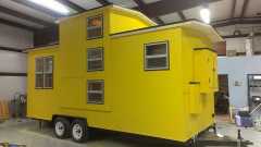 yellow caboose on wheels
