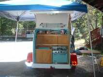 pic 551 new smaller stove and oven. new paint .allum around the stove to keep the heat off the wood