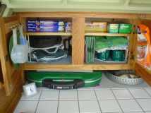 Lots more fit in these Home Depot cabinets after I added a shelf made from leftover birch and then added trim to it.