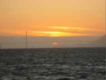 Treasure Island Trip- sunset with sun under bridge