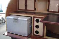 pull out cooler and wine rack. Fold up table. Black laminate tops