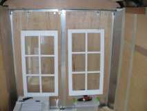 mock up of false wall with windows and air conditioner