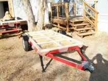 (0147) I placed a 4x8 sheet of plywood on the trailer to have a flat surface to build the wooden frame. I taped waxed paper on the plywood so the Gorilla glue didn't stick to the plywood. I used my Kreg jig and the Gorilla glue to secure all joints.