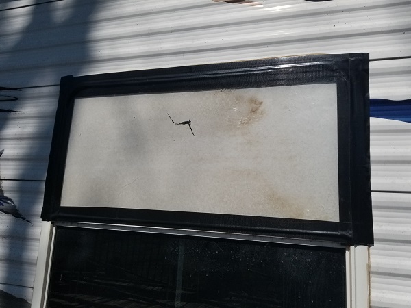 temporary polycarbonate window fix (left the paper on it).jpg