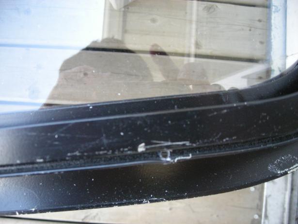 holes in window frame.JPG