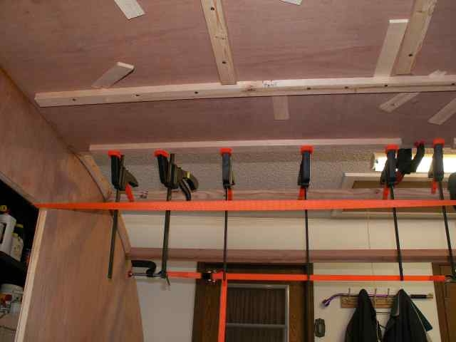 Clamping the ceiling panel to a spar