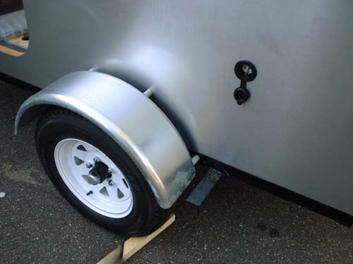 Fender attachment with plastic conduit spacers.