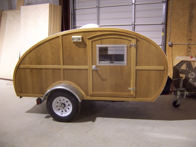 Trim done, Epoxy coated, 4 coats spar varnish, fenders and new (larger) wheels!