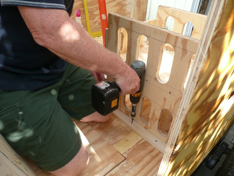 Installing stops for bathroom/shower wall next to water heater.