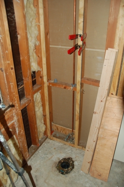 new throne plumbing to attic and furring out wall a half inch
