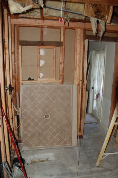 shower pan, new drain trench, and opening for new closet