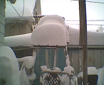 Snow on top of a shed