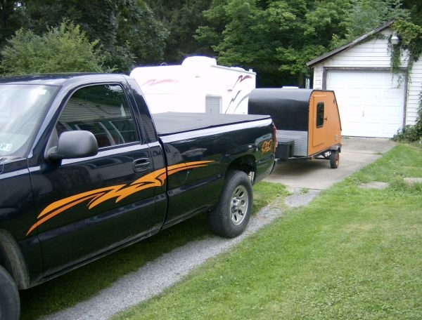 Truck with new graphics hooked up to teardrop