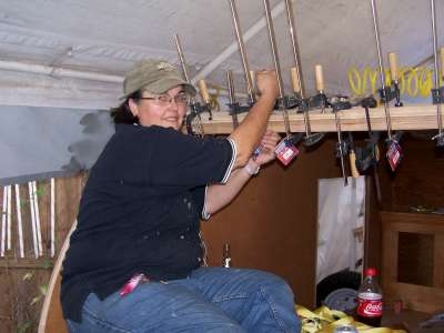 Peggy putting clamps on roof