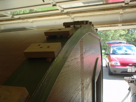 Side view of trim being held in place until glue dries.