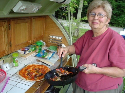 After sauteing the veggies, Rose adds them to the thin pizza crust.