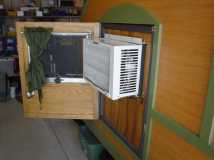 Air conditioner installed using an insert.