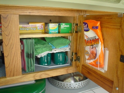 The new shelf rests on two corner organizers and I'm real happy with the increase of space for the galley caninet.