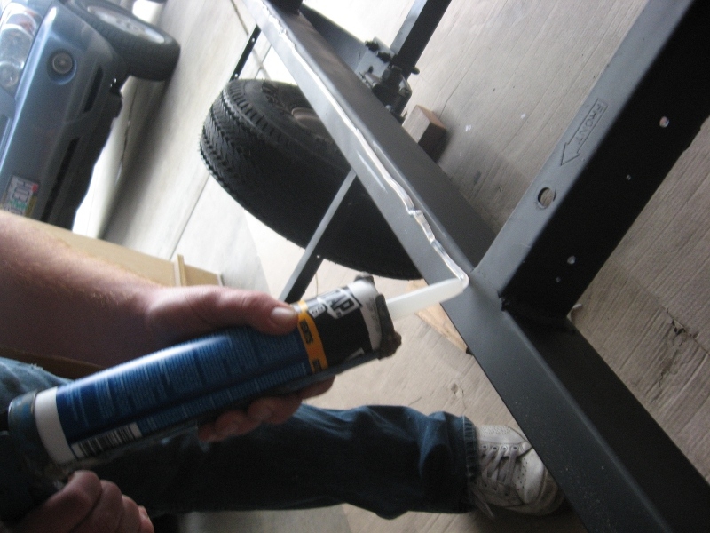 Caulking before laying the floor down.