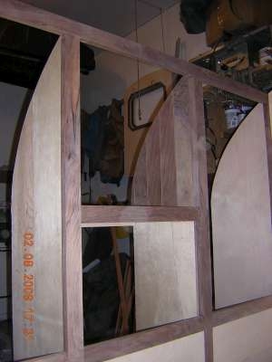 Walnut trim and paneling in alcove at forward cabinets