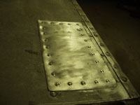 Top holes receiving patches with buck rivets