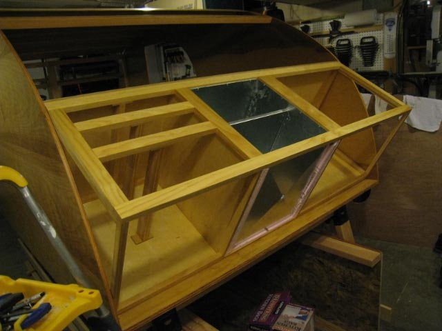 Installing a replica icebox before the galley cabinet is installed