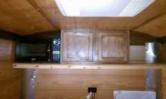 Overhead cabinet and microwave.