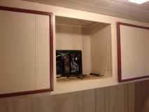 Electric Panel and rear cabinets with doors.